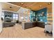 Inviting common area with a modern kitchen, fireplace, and stylish furnishings for socializing at 22 Apache Plume St, Brighton, CO 80601