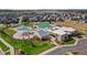 Aerial view of a community pool and recreational area with lush landscaping and ample seating at 22 Apache Plume St, Brighton, CO 80601