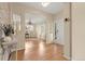 Inviting home foyer features stylish light colored hardwood floors and white trim at 22 Apache Plume St, Brighton, CO 80601