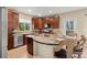Updated kitchen with stainless steel appliances, breakfast bar, and hardwood floors at 22 Apache Plume St, Brighton, CO 80601