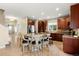 Spacious kitchen featuring a large island with seating, stainless steel appliances, and hardwood floors at 22 Apache Plume St, Brighton, CO 80601