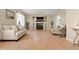 Comfortable living room with hardwood floors, neutral decor, and a decorative fireplace at 22 Apache Plume St, Brighton, CO 80601