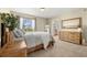 Comfortable main bedroom featuring carpet, a dresser, and lots of natural light and a view to the exterior at 22 Apache Plume St, Brighton, CO 80601