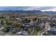 Aerial shot of a modern gray home with fenced yard, patio, second story balcony, and mountains in the distance at 1353 Quaker St, Golden, CO 80401