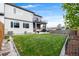 Spacious backyard featuring green lawn, patio area, and fence, ideal for outdoor activities at 1353 Quaker St, Golden, CO 80401