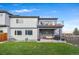 Charming backyard featuring a patio, lawn and second story balcony in a modern grey home at 1353 Quaker St, Golden, CO 80401