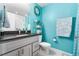 Stylish bathroom with bright blue walls, white subway tile shower, and modern gray vanity at 1353 Quaker St, Golden, CO 80401