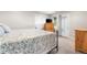 Bright bedroom featuring a soft, floral patterned comforter, wooden dressers and a door to the outside at 1353 Quaker St, Golden, CO 80401