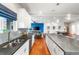 Open-concept kitchen with stainless steel sink, white cabinets, and a view into the living area at 1353 Quaker St, Golden, CO 80401