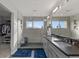Bright bathroom featuring a walk-in shower, dual vanity, and mountain views at 1353 Quaker St, Golden, CO 80401