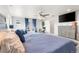 Large main bedroom with king bed, ceiling fan, balcony access, and plenty of natural light at 1353 Quaker St, Golden, CO 80401