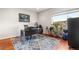 Bright home office featuring a modern desk, vibrant plants, and stylish rug at 1353 Quaker St, Golden, CO 80401