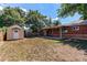 Backyard with covered patio, brick exterior, and storage shed at 9150 Lilly Ct, Thornton, CO 80229