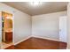 A clean, neutral bedroom with laminate floors and a doorway leading to the bathroom at 9150 Lilly Ct, Thornton, CO 80229