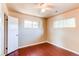 Neutral bedroom featuring wood floors, two windows allowing natural light, and ceiling fan at 9150 Lilly Ct, Thornton, CO 80229