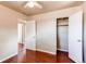 Neutral bedroom with wood floors, ceiling fan, and open closet at 9150 Lilly Ct, Thornton, CO 80229