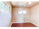 Neutral bedroom with wood floors and two windows allowing lots of natural light at 9150 Lilly Ct, Thornton, CO 80229