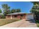 Ranch style red brick home featuring a well-kept lawn and attached garage at 9150 Lilly Ct, Thornton, CO 80229
