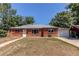 Red brick home featuring a well-kept lawn, and an attached garage with a driveway at 9150 Lilly Ct, Thornton, CO 80229