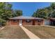 Charming red brick home with a well-maintained front yard and attached one car garage at 9150 Lilly Ct, Thornton, CO 80229
