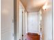 Hallway with fresh paint, wood floors, built in cabinets and doors to other rooms at 9150 Lilly Ct, Thornton, CO 80229