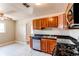 Spacious kitchen area featuring wood cabinets, stainless steel dishwasher, and a double sink at 9150 Lilly Ct, Thornton, CO 80229