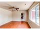 Living room featuring hardwood floors, ceiling fan and a large window for ample natural light at 9150 Lilly Ct, Thornton, CO 80229