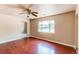 Living room showcasing beautiful hardwood floors, ceiling fan and large window overlooking the yard at 9150 Lilly Ct, Thornton, CO 80229