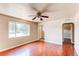 Open living area features hardwood floors, a ceiling fan and large windows at 9150 Lilly Ct, Thornton, CO 80229