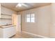 Functional mud room with a utility sink, a window, tile floors, and white cabinets at 9150 Lilly Ct, Thornton, CO 80229