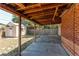 Spacious covered patio area with view to fenced backyard and small storage shed at 9150 Lilly Ct, Thornton, CO 80229