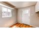Storage room showcasing natural light through windows and an access door to the exterior at 9150 Lilly Ct, Thornton, CO 80229