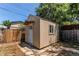 Small storage shed in a fenced backyard with a single door and window at 9150 Lilly Ct, Thornton, CO 80229