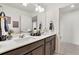 Bright bathroom featuring double sinks with a vanity, and a large mirror at 15833 Little Bluestem Rd, Monument, CO 80132