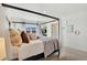 Spacious bedroom features a four-poster bed, a window with a mountain view, and neutral-toned decor at 15833 Little Bluestem Rd, Monument, CO 80132
