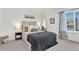 Bedroom showcasing a comfortable queen-sized bed, a decorative mirror, and natural light to enhance the serene atmosphere at 15833 Little Bluestem Rd, Monument, CO 80132