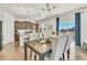 Elegant dining area features a large table, comfortable seating, and seamless access to the modern kitchen at 15833 Little Bluestem Rd, Monument, CO 80132