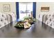 Cozy dining room showcasing a dark wood table, tufted chairs, and decorative centerpiece at 15833 Little Bluestem Rd, Monument, CO 80132