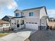 Charming two-story home boasts a covered front porch, attached two-car garage and inviting curb appeal at 15833 Little Bluestem Rd, Monument, CO 80132