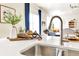 Bright kitchen features a quartz countertop, modern fixtures, and open layout, perfect for cooking and entertaining at 15833 Little Bluestem Rd, Monument, CO 80132