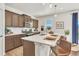 Modern kitchen boasts a spacious center island, stainless steel appliances, and stylish pendant lighting, perfect for entertaining at 15833 Little Bluestem Rd, Monument, CO 80132