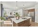 Open-concept kitchen features a large island, stainless steel appliances, and seamless flow into the living area at 15833 Little Bluestem Rd, Monument, CO 80132