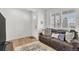 Welcoming living room features a brown couch, natural light, and a neutral rug, creating an inviting atmosphere at 15833 Little Bluestem Rd, Monument, CO 80132