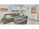 Inviting living room with gray sectional, ottoman, and bright natural light at 15833 Little Bluestem Rd, Monument, CO 80132