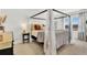 Comfortable bedroom with a canopy bed, decorative pillows, and soft natural light at 15833 Little Bluestem Rd, Monument, CO 80132