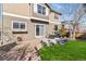 A well-maintained backyard with patio, grass lawn, rock garden, and yellow umbrella at 9378 Longstone Dr, Parker, CO 80134