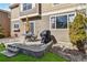 A well-maintained backyard with patio, grass lawn, rock garden, and yellow umbrella at 9378 Longstone Dr, Parker, CO 80134