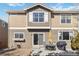 A well-maintained backyard with patio, grass lawn, rock garden, and yellow umbrella at 9378 Longstone Dr, Parker, CO 80134