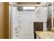 Bright bathroom with bathtub, white tiling, and a shower-head at 9378 Longstone Dr, Parker, CO 80134