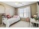 Stylish bedroom with plush bedding, a decorative macrame, and a study desk at 9378 Longstone Dr, Parker, CO 80134